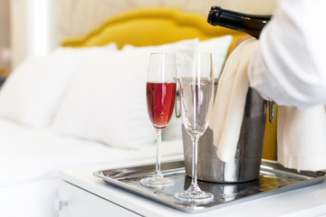 Honeymoon concept. Champagne bucket near bed in a hotel room