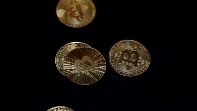 Gold coins bitcoin on a black background