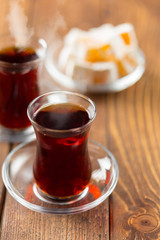 Red tea in turkish glasses on a wooden table