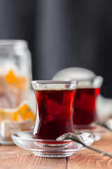 Red tea in turkish glasses on a wooden table