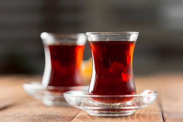Red tea in turkish glasses on a wooden table