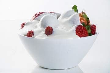 Strawberry with chantilly in white bowl on white background