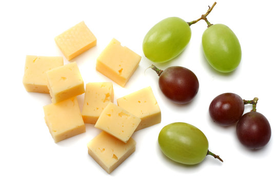 piece of cheese with grapes isolated on white background