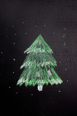 Christmas tree silhouette chalked on a blackboard. New year minimalism concept.