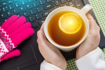 Blogger, freelancer, background picture of the winter season - laptop, gloves, hot drinks