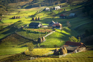 Green valley with rural houses. Romania