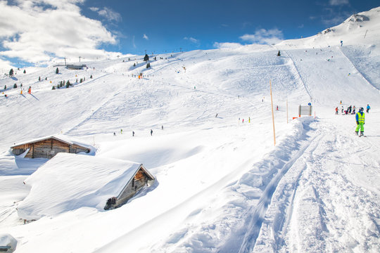 People skiing on prepared slopes covered by fresh snow in Tyrolian Alps, Zillertal, Austria, Europe