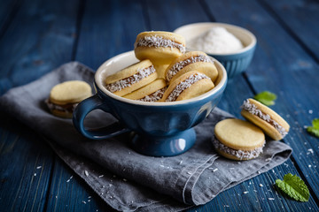 Alfajore cookies filled with caramelized milk and coconut - obrazy, fototapety, plakaty