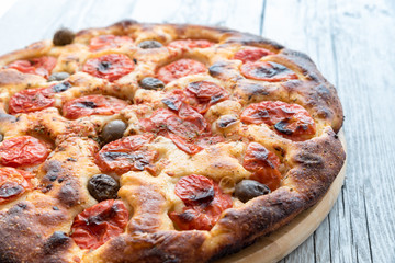 Focaccia typical of Bari Italy with tomatoes and olive