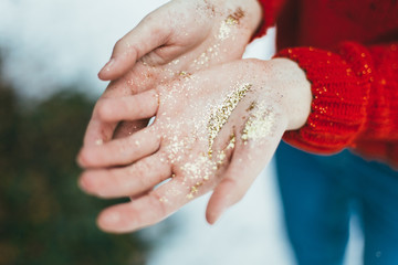 Golden glitter in hands
