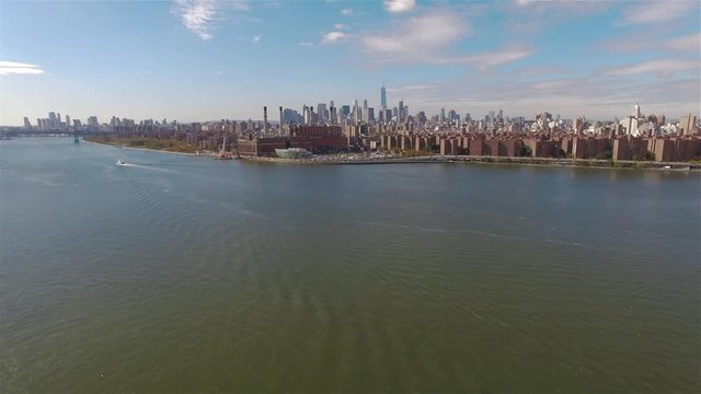 Real time aerial shot of a power station in New York City. Camera is flying in the air and filming Power Station and Downtown Manhattan.