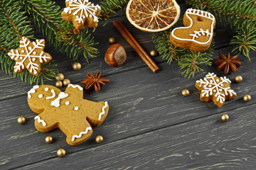 Christmas composition. Cinnamon sticks, anise, gingerbread, hazelnuts and oranges on old wooden table. Top view.