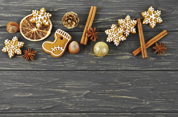 Christmas composition. Cinnamon sticks, anise, gingerbread, hazelnuts and oranges on old wooden table. Top view.