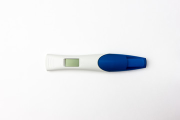 Pregnancy test on a white background. Electronic pregnancy test close-up on a white background.