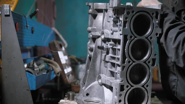 Close up shot of a automechanic tightening bolt on engine block