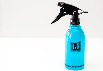 Blue Plastic Spray Bottle on a White Background 