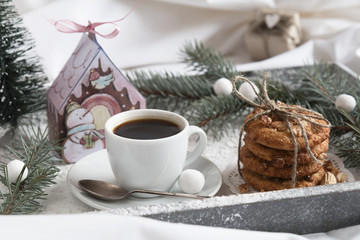 Christmas Breakfast in bed on a tray with snow, gifts, fir-tree and tangerines.