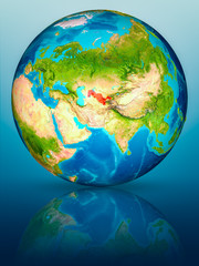 Uzbekistan on Earth on reflective surface