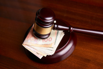 Law mallet or auctioneer's hammer and money stack