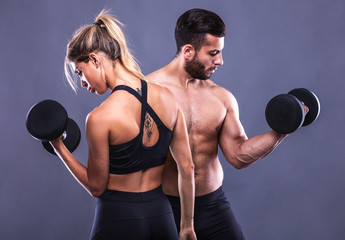 fitness woman and man on a gray background