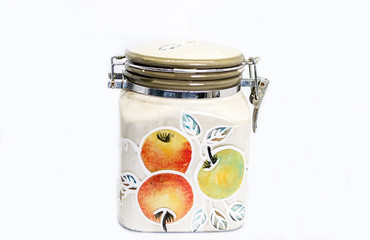Ceramic jar with apples on white background