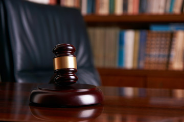 Judge gavel on wooden table in library