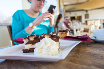 Pregnant woman taking a snapshot of delicious cake.