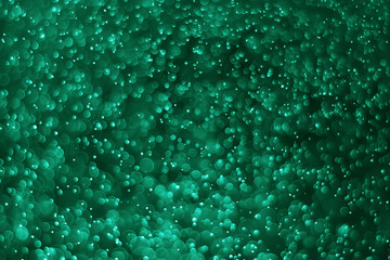 green bokeh.Bokeh of water with black background, tinted green  for background