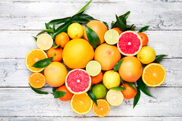 Fresh citrus fruits background. Orange, grapefruit, lemon, lime, tangerine. Mix citrus fruits with...