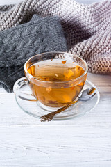 Cup of tea, knitted mittens and scarf