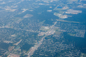 Fototapeta na wymiar Metropolis Area of Houston, Texas Suburbs from Above in an Airplane