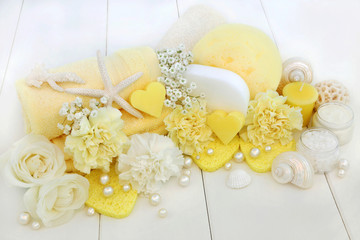 Beauty treatment cleansing and spa accessories including ex foliating salt, moisturising cream, heart shaped soaps, sponges,rose and carnation flowers.