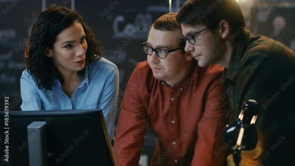 Poster three office employees have discussion about ongoing project, they point at personal computer screen
