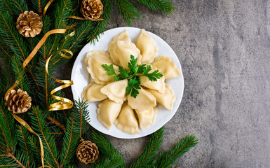 Christmas dumplings with decoration on a white plate. Top view.