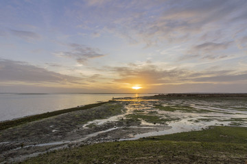 Sunset seascape of Olhao salt marsh Inlet waterfront to Ria Formosa natural park. Algarve.