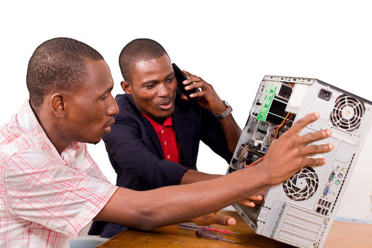 two computer scientists repair a computer