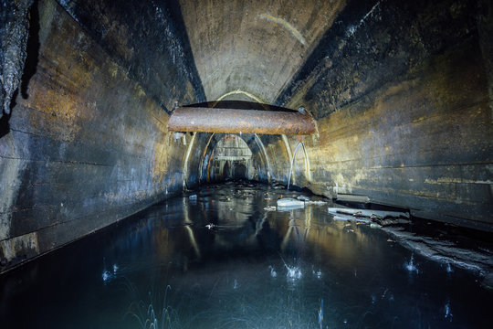 Flooded by dirty industrial wastewater sewage collector. Sewer tunnel under city