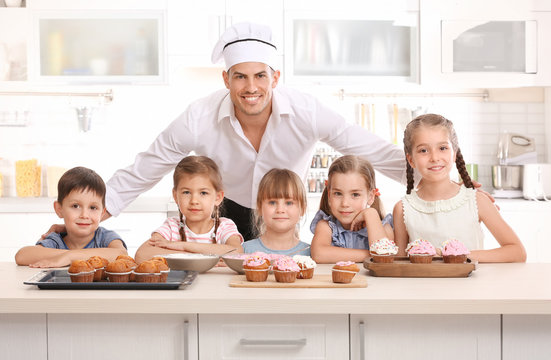 Group of children and teacher in kitchen during cooking classes