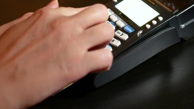 Hand insert credit card in pin pad of pos terminal.