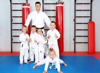 Male karate instructor with little children in dojo © Africa Studio