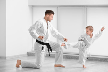 Little boy with instructor practicing karate in dojo © Africa Studio