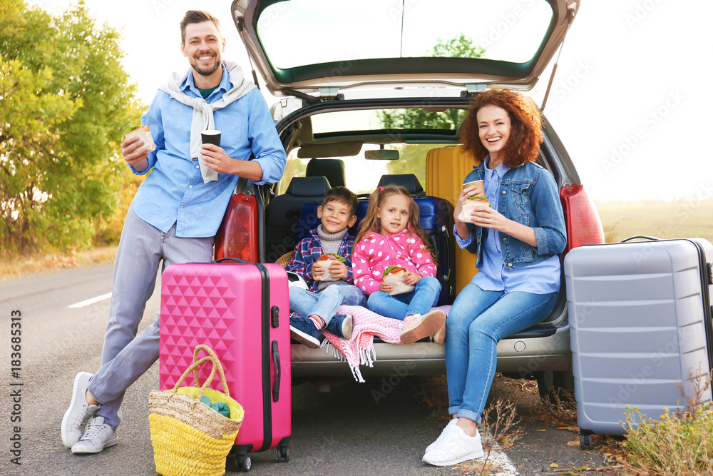 Wall mural young family with children near car, outdoors