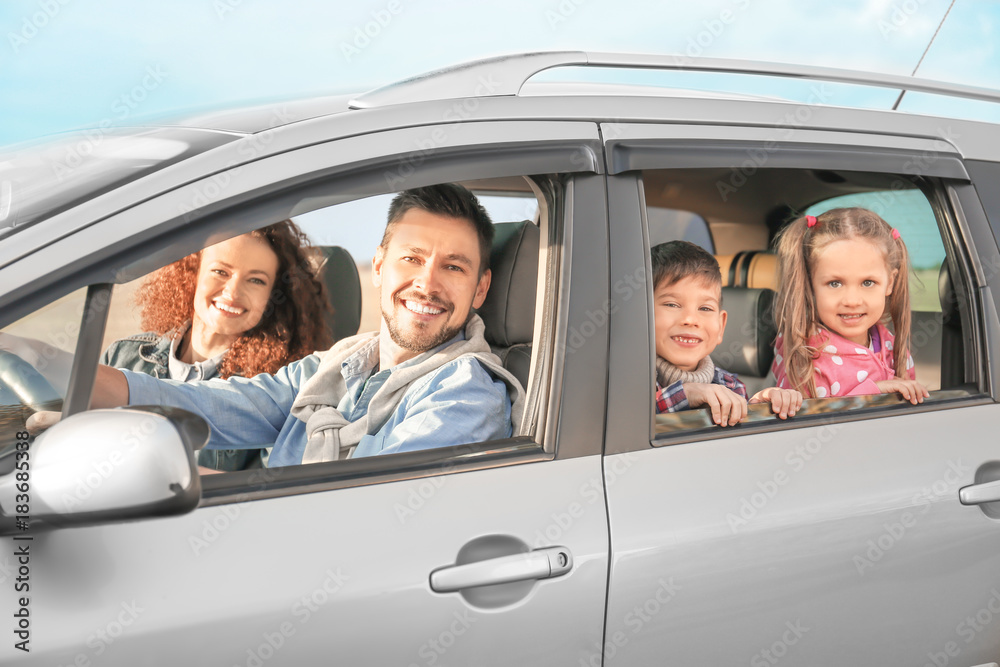 Wall mural young family with children in car