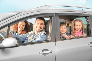 Young family with children in car