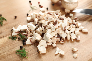 Fototapeta na wymiar Fresh sliced champignon mushrooms on wooden board