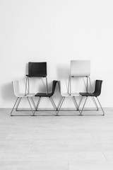Obraz premium Composition with modern chairs near light wall