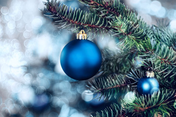 Christmas background - baubles and branch of spruce tree