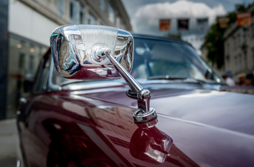 Wing mirror of classic car at a car rally in Gloucester