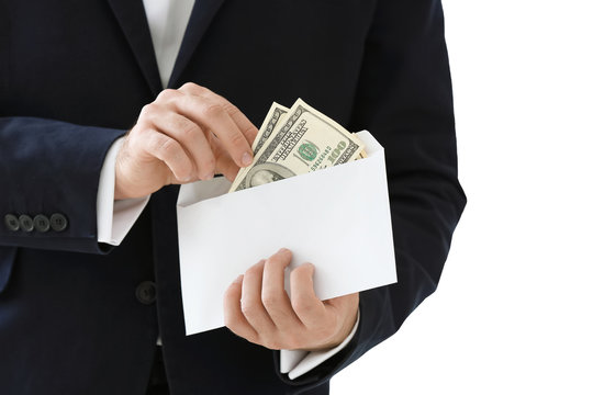 Businessman with money in envelope on white background. Corruption concept
