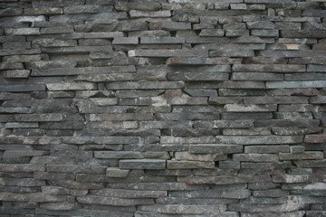 Wall of layered stone with textures of hewn stone 